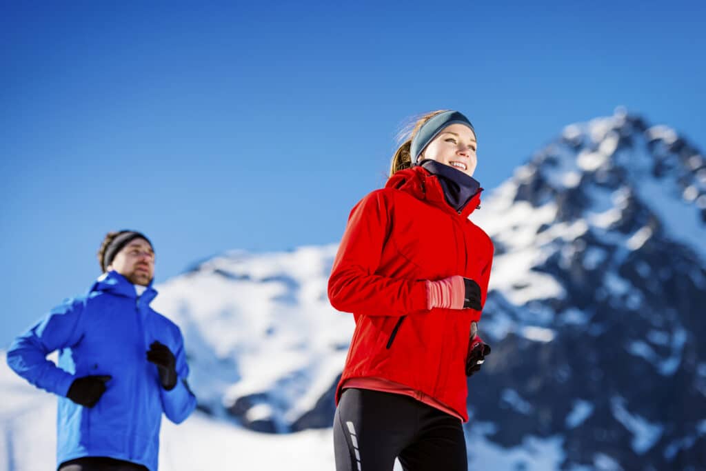 healthy couple jogging in the mountains